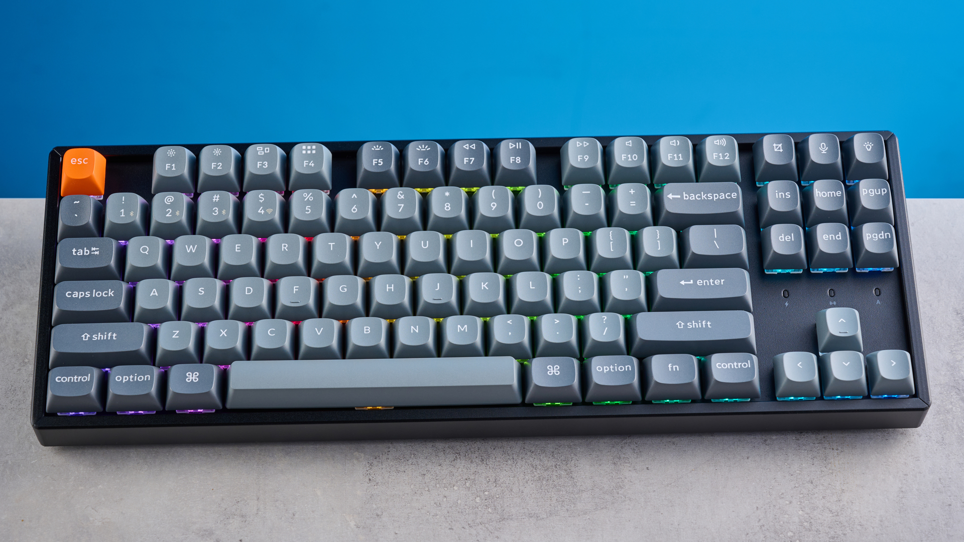 Keychron K8 Max mechanical keyboard in gray photographed on a blue background