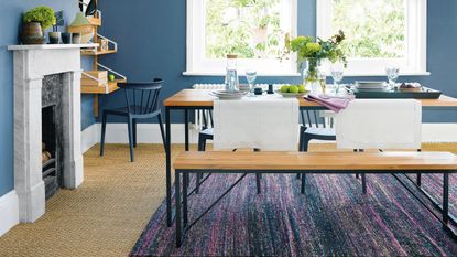 Blue dining room with floral blinds, sisal carpet and stone fireplace