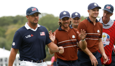 Bryson DeChambeau, Tommy Fleetwood and Justin Rose walk off the green