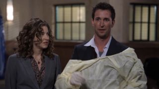 Hallee Hirsh looks over at Noah Wyle as he scrubs up for action in the ER series finale.