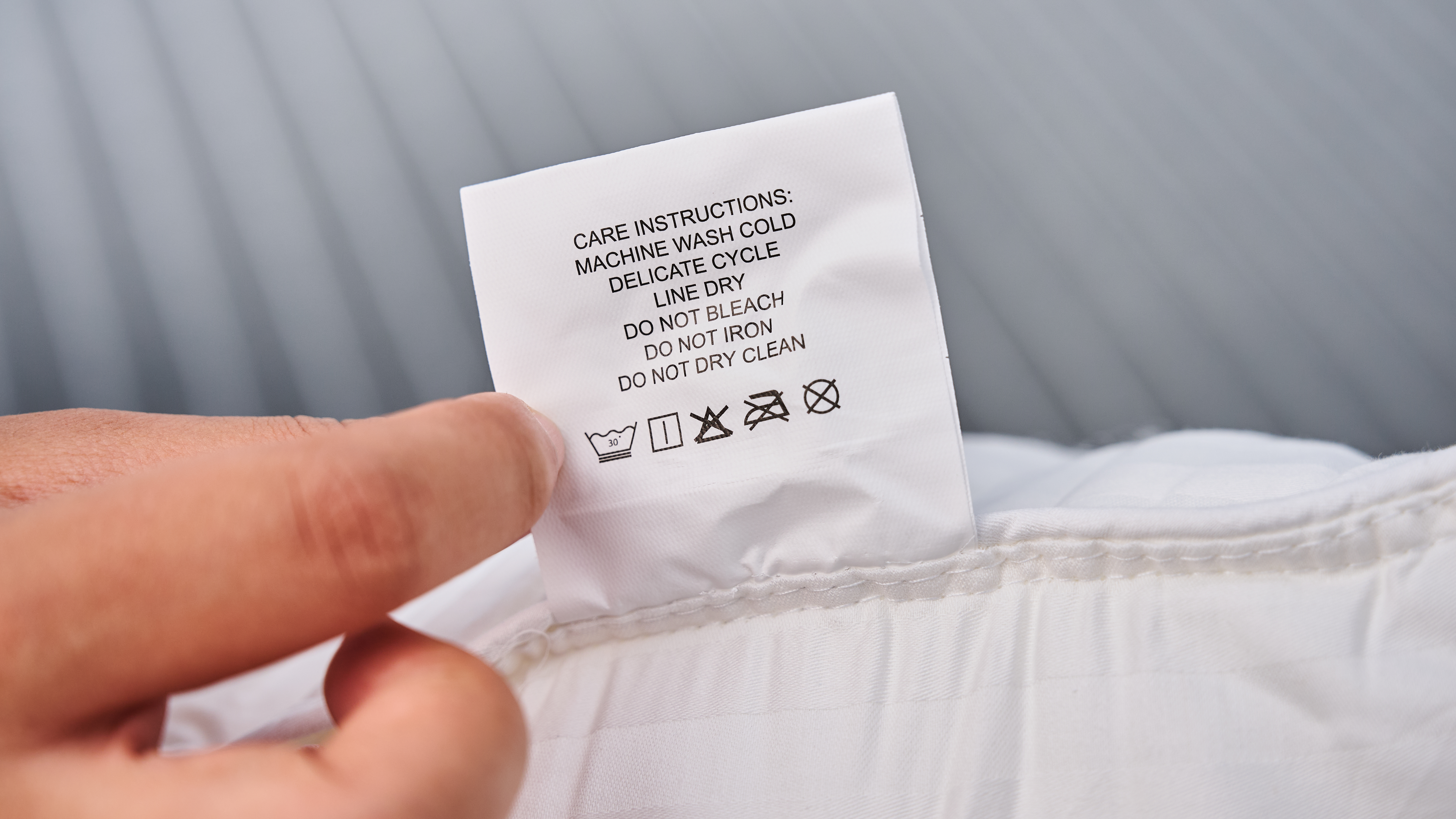 A close-up shot of the care tag attached to the pillow