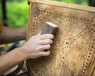 removing paint from antique chair with sandpaper