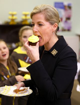 Sophie, Countess of Wessex, President of Girlguiding, eats a Brownies 100th birthday cupcake as she visits 5th Frimley Brownies