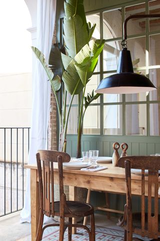 a balcony with a dining table on