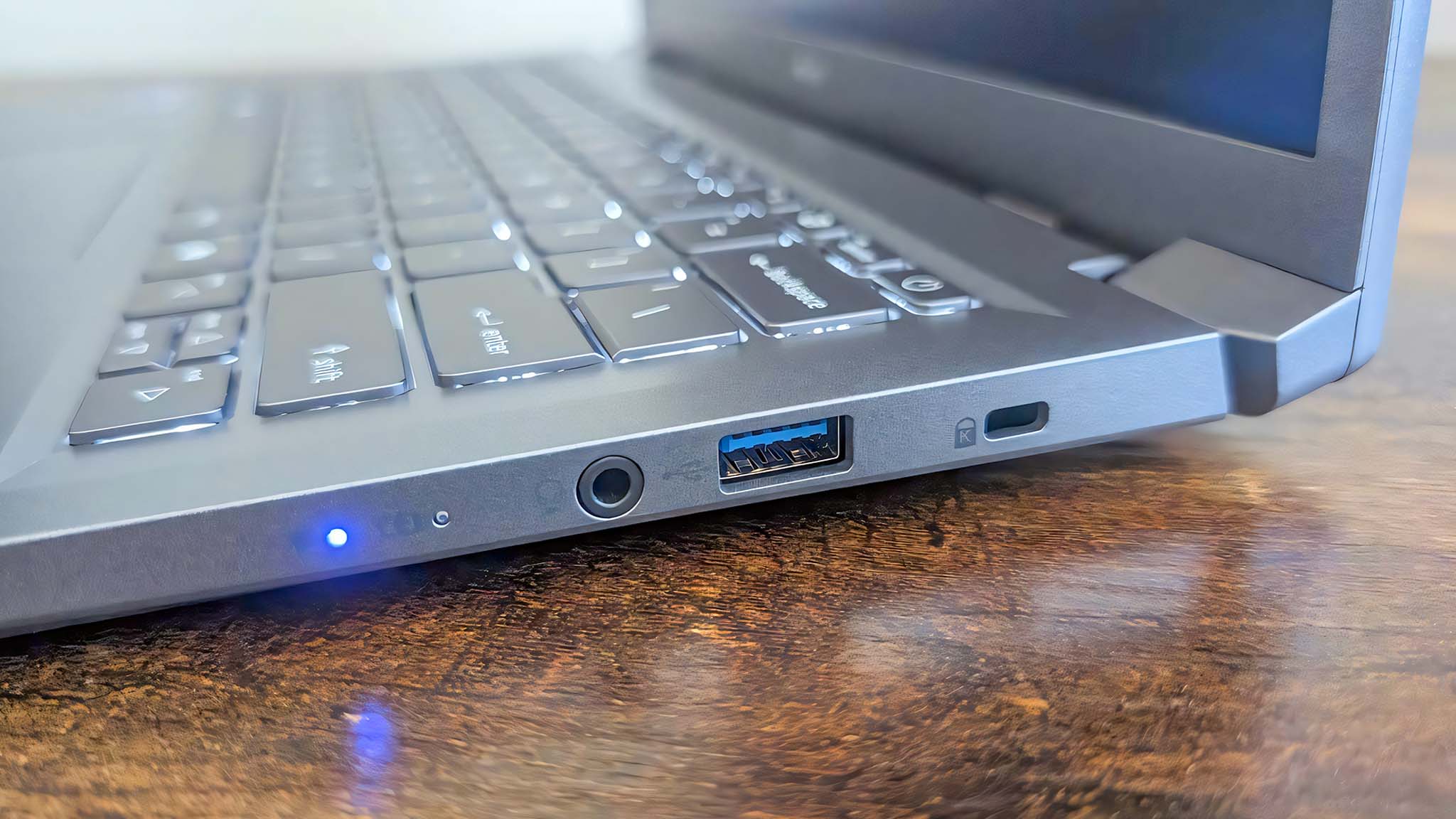 Close up of the Acer Aspire 14 AI's left side, which has a headphone jack, USB-A port, and Kensington lock. 