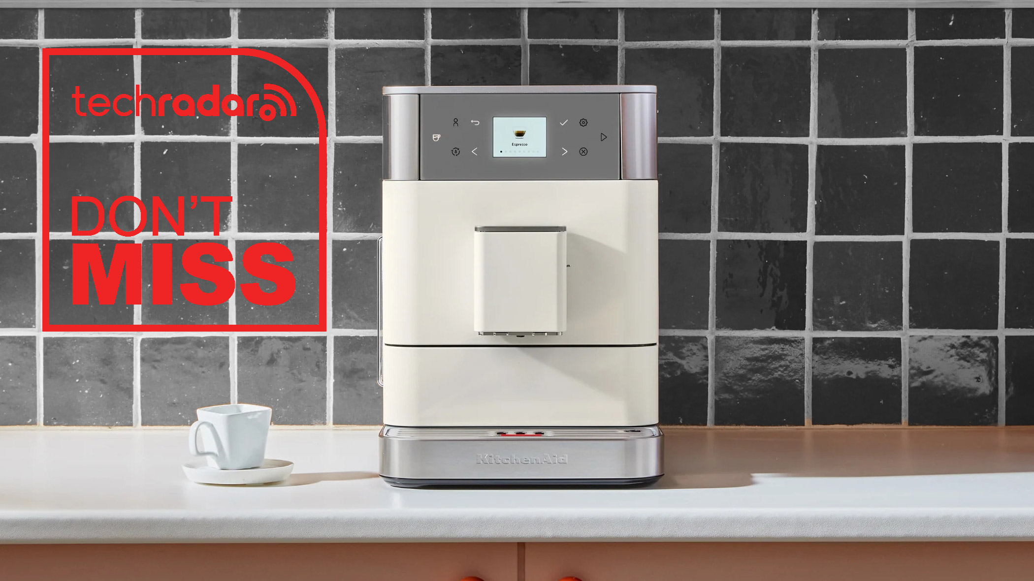 KitchenAid KF6 espresso machine in cream on a kitchen counter.