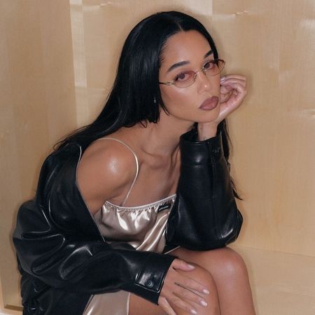 a close-up shot of Laura Harrier wearing a long hairstyle with glasses