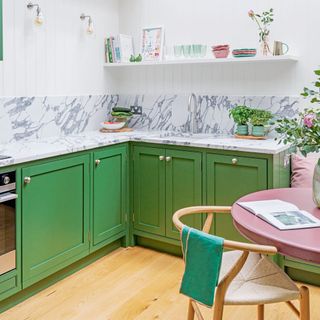 green kitchen with marble splashback and skylight