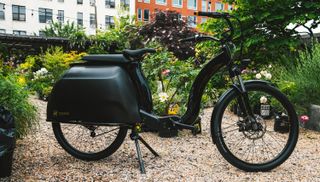 The Civilized Cycles Model 1 electric bike in a garden.