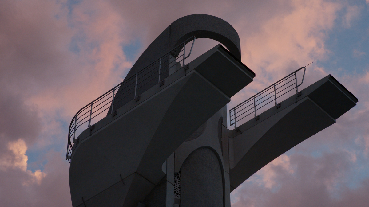 high-diving tower seen against the sky at dusk