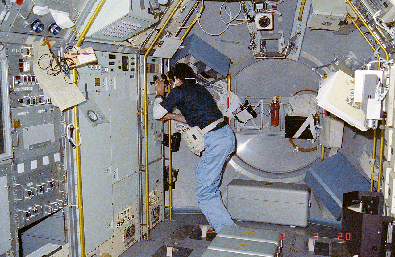 STS-51B payload specialist Lodewijk van den Berg observes the growth of mercuric iodide crystal in the vapor crystal growth system inside the Spacelab module on space shuttle Challenger.