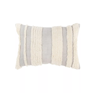 A fringed grey boho style lumbar pillow