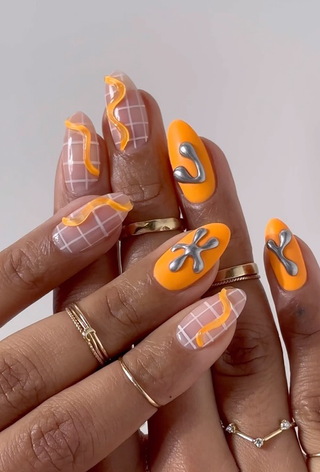 A manicure featuring a graphic design and 3D nail art by Imarni.