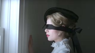 Lucy Boynton as Polly Parsons with a blindfold on during the trailer for the Netflix horror movie, I am the Pretty Thing that Lives in the House.