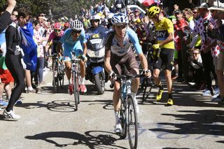 Romain Bardet (AG2R-La Mondiale) riding past a stationary Froome