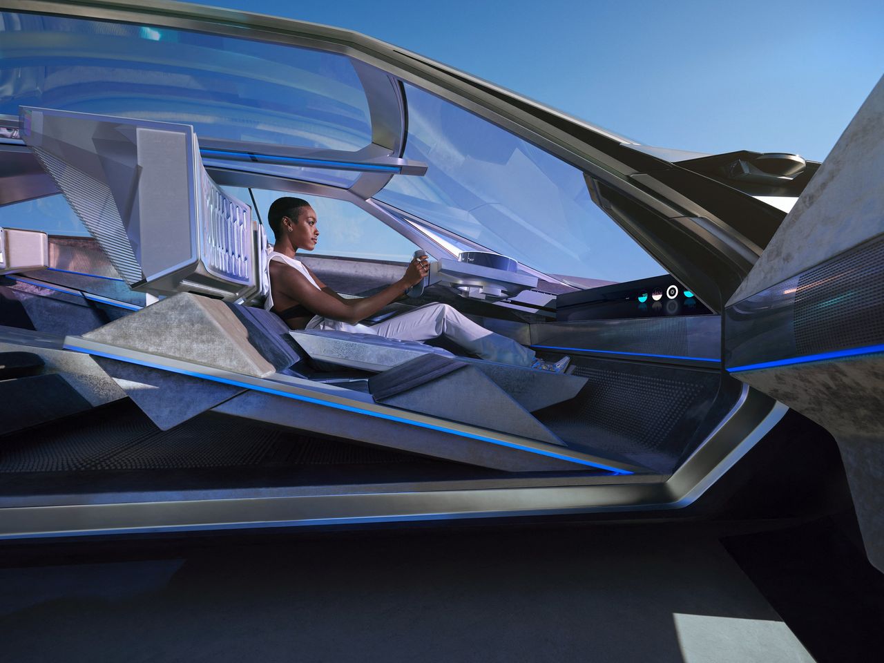 Person at wheel inside Peugeot Inception Concept Car, 2023