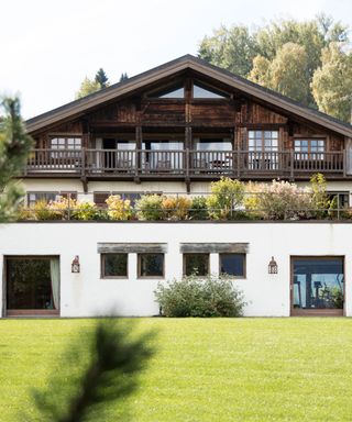 A large chalet style house with garden wall lights