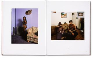 Open photo book with African woman standing in underwear on left page and two African men without shirts on sitting on a couch on the right page.