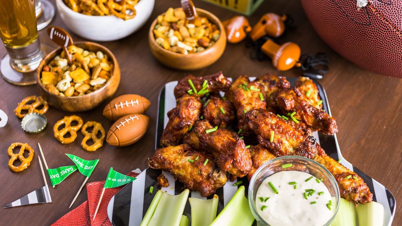 Super bowl party checklist - appetisers on a table with mini american footballs as decoration