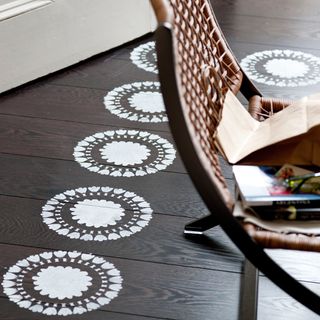 stencil design wooden floorboards and wooden chaird