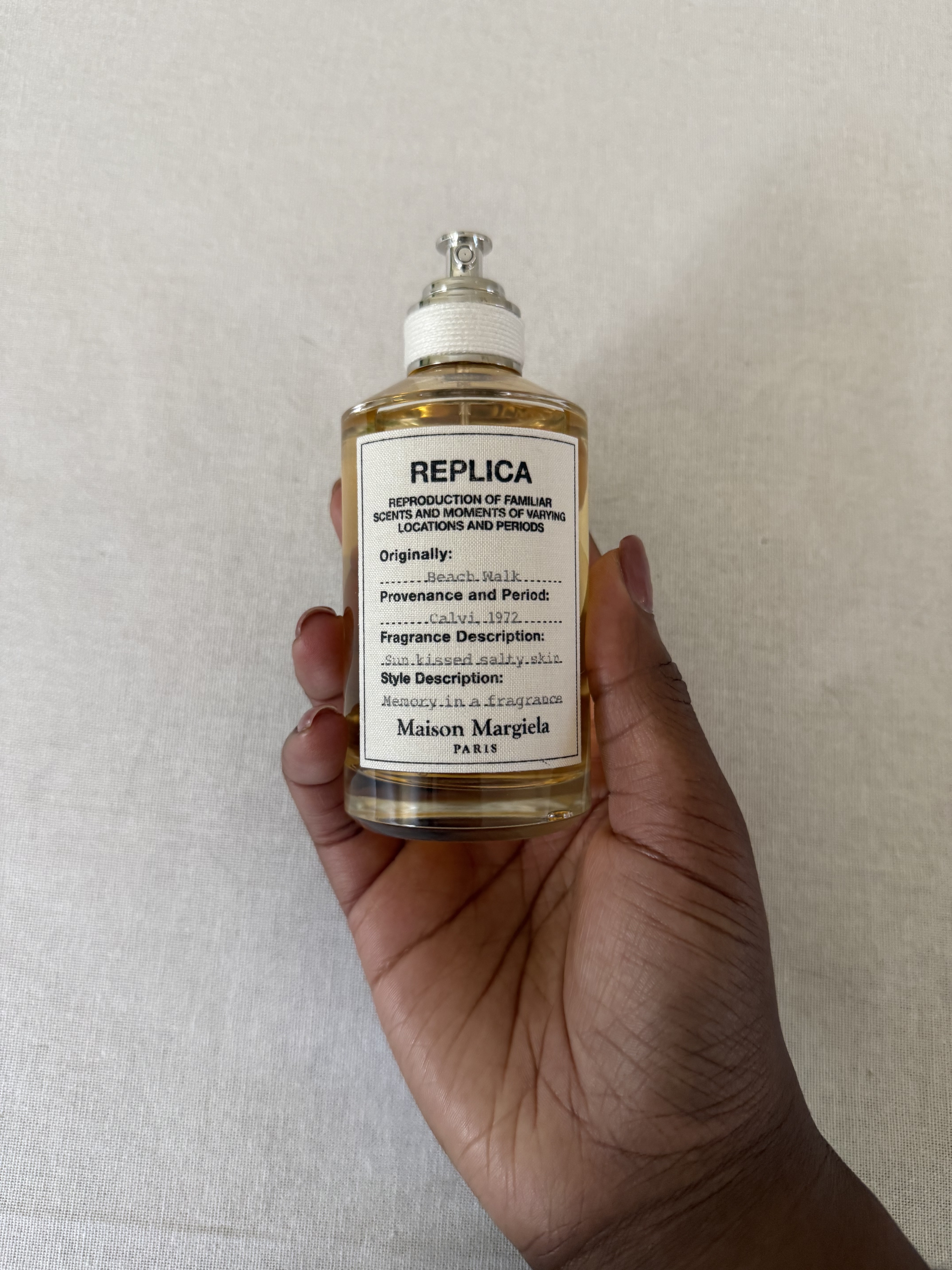 Thomas holds Maison Margiela Replica Beach Walk Eau de Toilette.