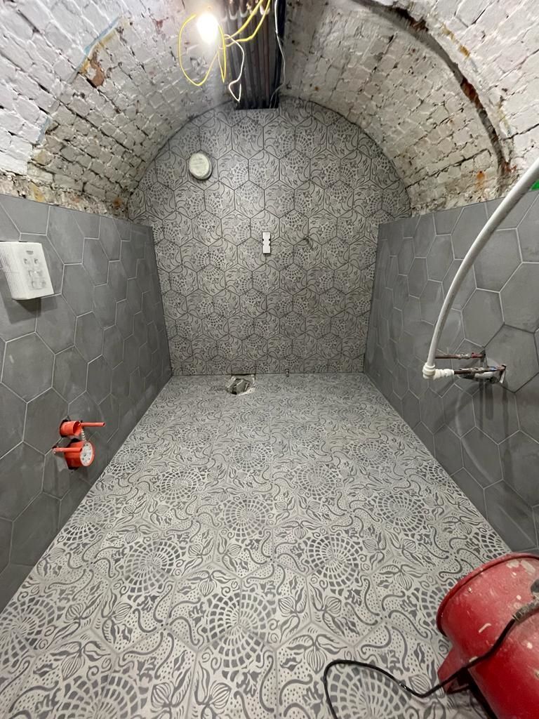Tiles all laid in the bathroom ready for toilet, sink and bath fittings to be added