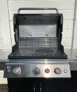 fully assembled Weber Genesis II EX-335 GBS smart barbecue against a wall
