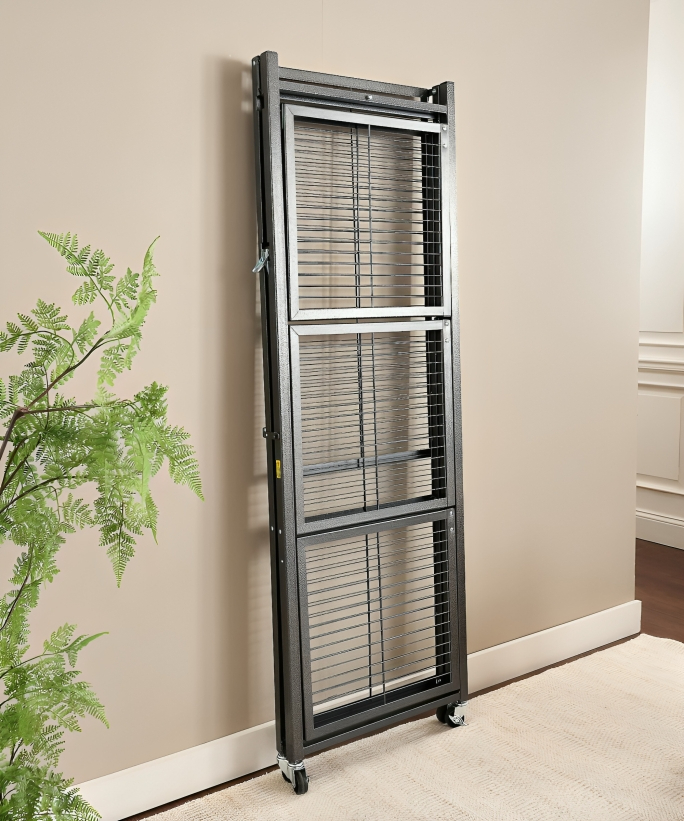 A black collapsing shelving unit propped up against a beige wall