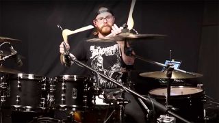 Drummer using coat hangers for drumsticks