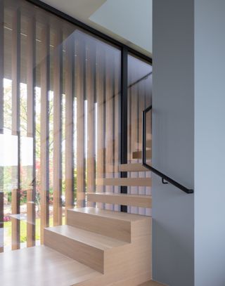 A minimalist wooden stairway with floating steps