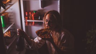 Woman snacking at night