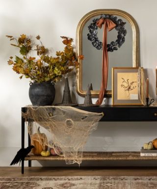 neutral hallway entry console table with halloween decor