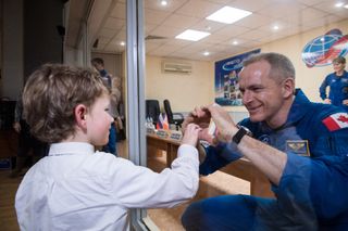 Canadian astronaut David Saint-Jacques says goodbye to his son during quarantine before his launch to the International Space Station.
