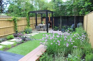 modern garden with pergola covered patio and outdoor fireplace