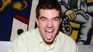 A photo of Fyre Fest's Billy McFarland sticking his tongue out in 2014