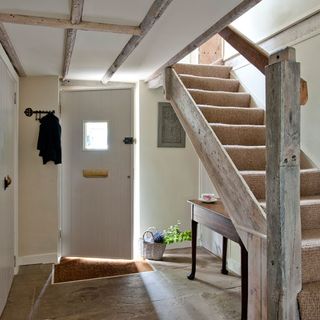 hallway with stairs and white door