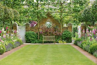long garden ideas: symmetrical plot with lawn, borders and central bench