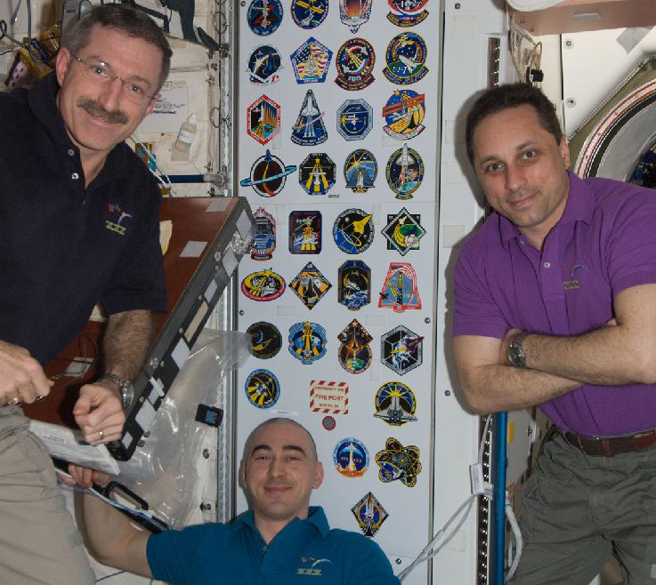 Expedition 30 commander Dan Burbank and Russian cosmonauts Anton Shkaplerov and Anatoly Ivanishin pose in the space station&#039;s Unity node.