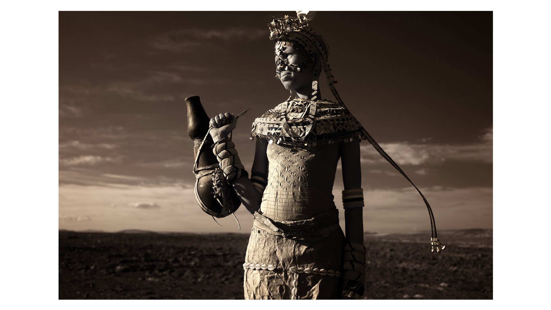 Photograph taken in Loiyangalani, Kenya, of a Rendile girl adorned in traditional attire, symbolising her readiness for marriage, by Piper Mackay. Overall winner of Travel Photographer of the Year 2024.