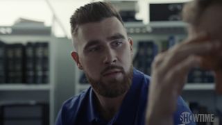 Travis Kelce wears a blue outfit in the show Moonbase 8