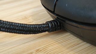 Close up of the braided cable on a black AOC GM510 gaming mouse