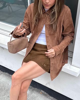 Rachelle Rowlings wearing a brown suede jacket