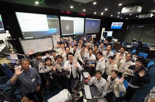 JAXA personnel mark the end of Hayabusa2's stay at the asteroid Ryugu on Nov. 13, 2019, in mission control.