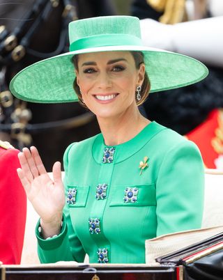 Kate Middleton in green dress and hat and sapphire and diamond earrings at Trooping the Colour