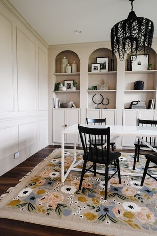 A dining room with four arched built in shelves made from IKEA Billy bookcases