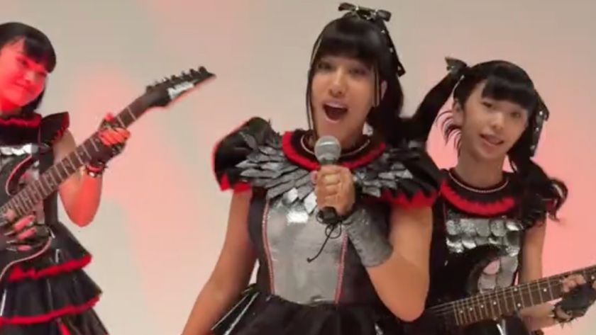 North West and two other young women dressed up as members of Babymetal against a white background