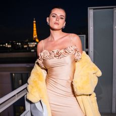 Bella Thorne on a balcony in Paris wearing a Coperni Spring 2025 look on a balcony in front of the eiffel tower