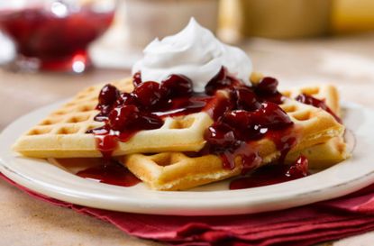 Waffles with almonds and cherry sauce