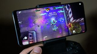 Person playing mobile game on Android phone