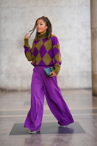 woman in purple and brown oversized sweater and purple wide-leg trouser
